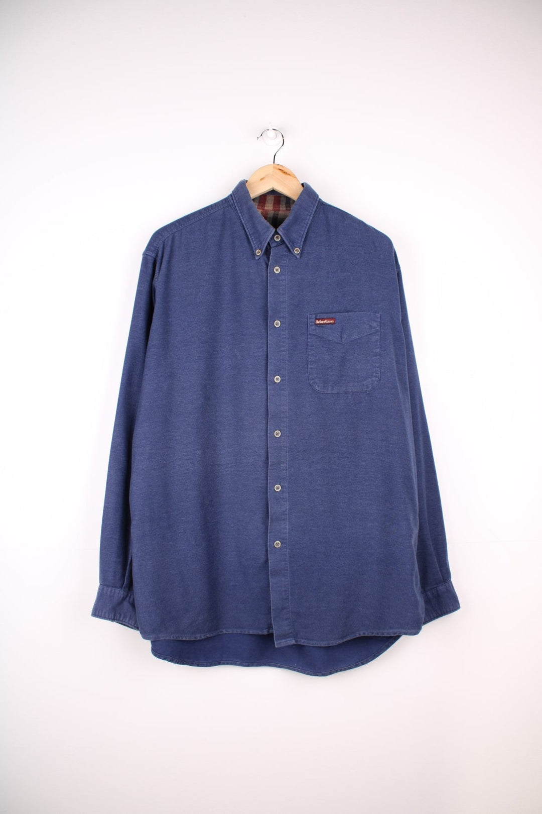 Marlboro Classics button-down shirt in blue with button closure, one chest pocket, and a small logo patch in red..