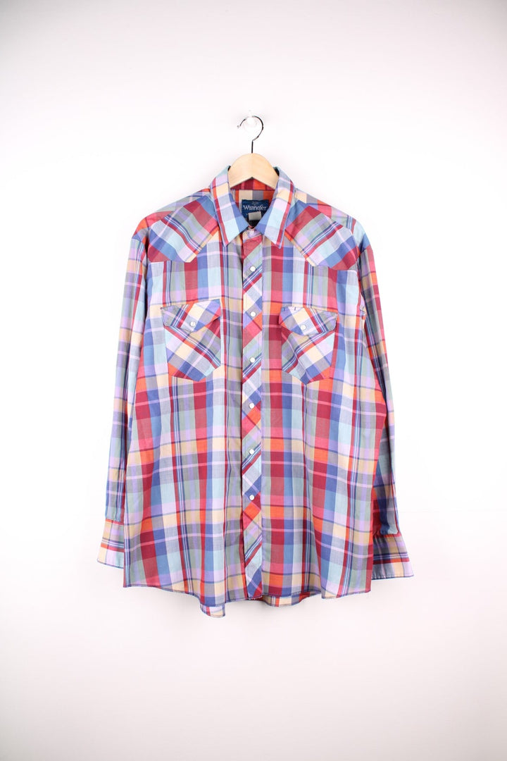 Wrangler western shirt in blue, red, yellow, and green check with two pockets and pearl-effect snap closure.