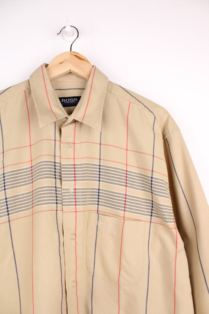 Vintage Hugo Boss shirt in tan with grey and red check design, button closure, one chest pocket and a small embroidered logo.