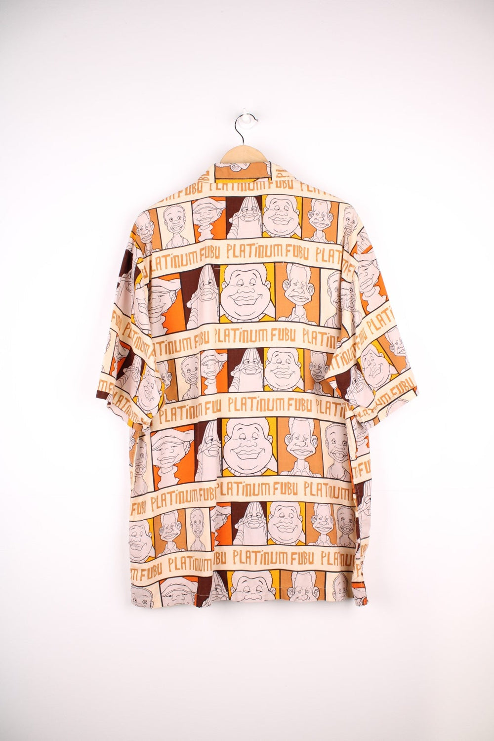 FUBU Platinum short-sleeved shirt in brown, orange and cream with cartoon print of Fat Albert and the Cosby Kids, button closure, one chest pocket, and a small logo tab in red.