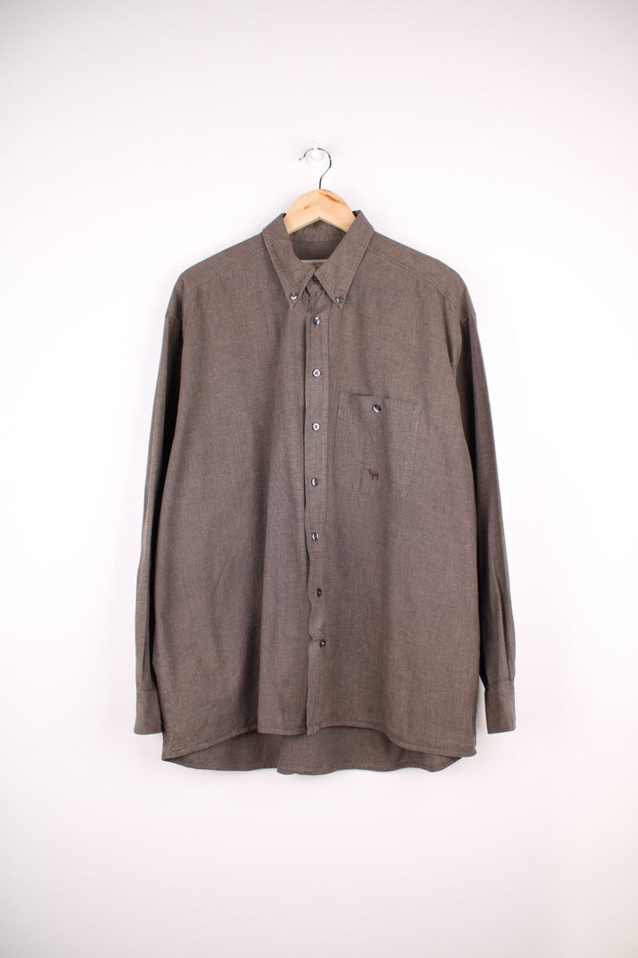 Camel button-down shirt in brown with button closure, one chest pocket, and a small embroidered camel logo. .