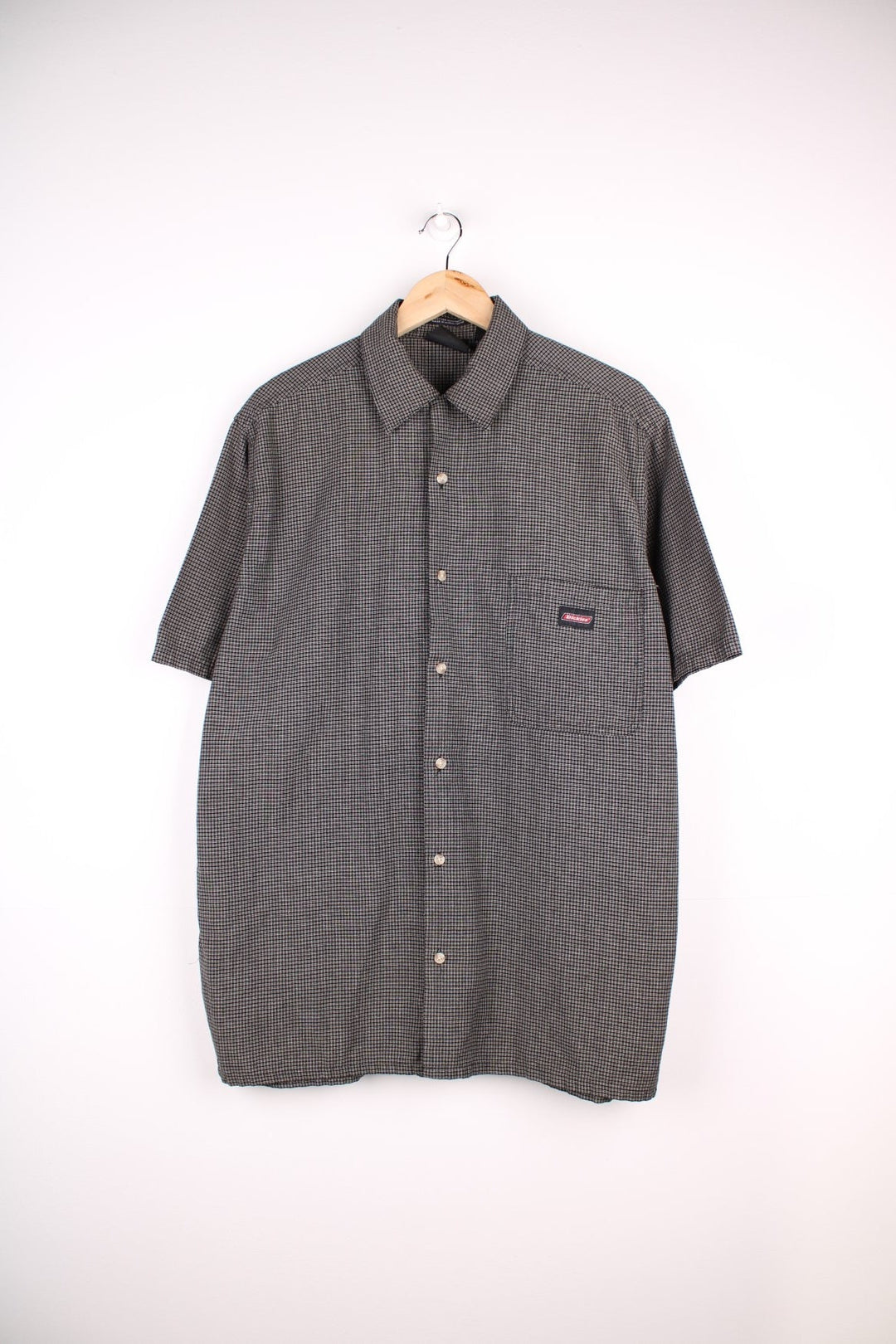 Dickies short-sleeved shirt in black and brown check with button closure, one chest pocket, and a 'Genuine Dickies' logo tag.