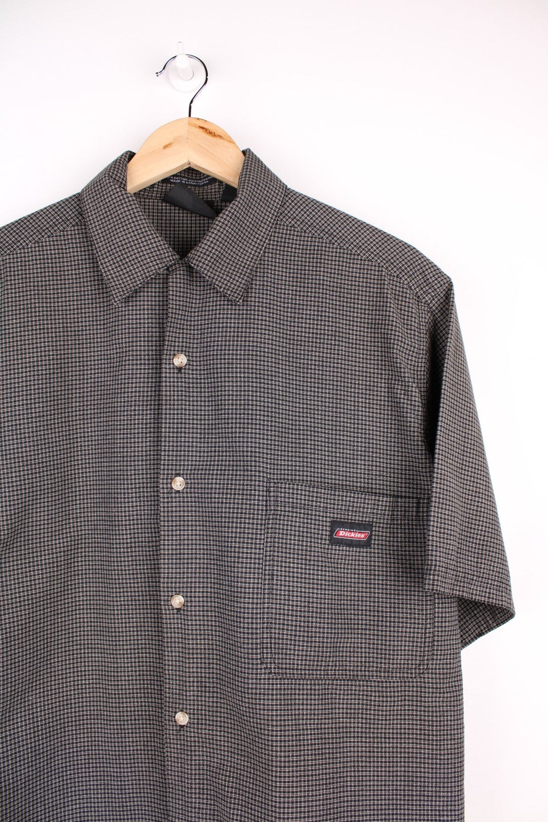 Dickies short-sleeved shirt in black and brown check with button closure, one chest pocket, and a 'Genuine Dickies' logo tag.