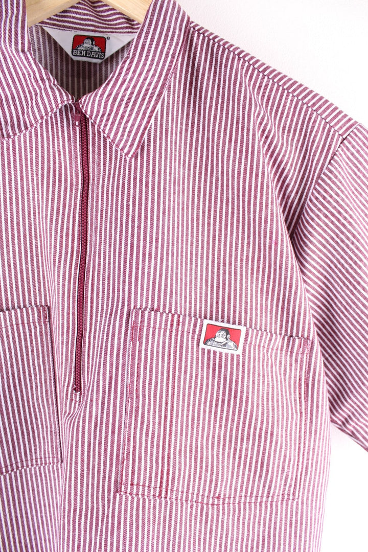 Ben Davis short-sleeved shirt in a red and white vertical stripe pattern with 1/2 zip closure, two breast pockets, and a small ape logo patch.