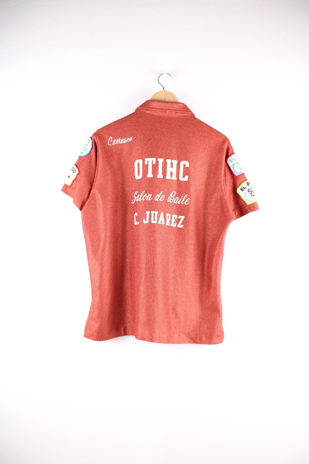 70s Vintage King Louie bowling shirt in metallic orange with a player name and club emblazoned on the front and back, and various competition patches on the sleeves.