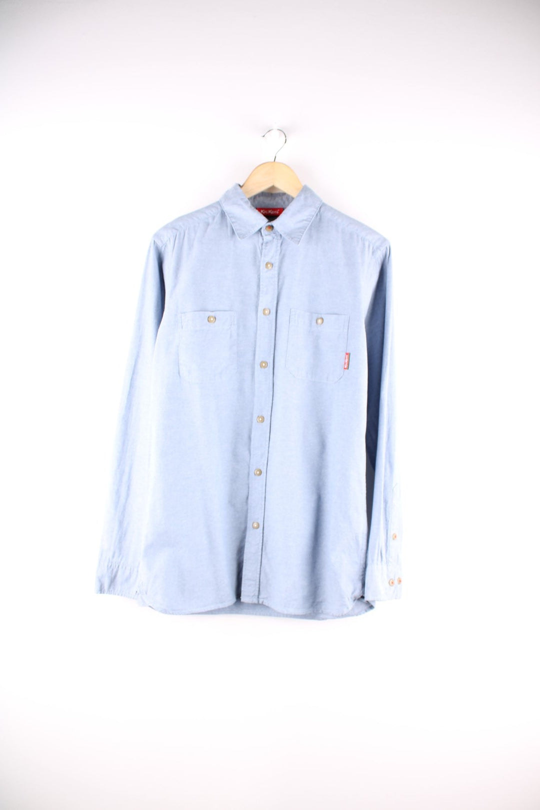 Kickers denim shirt in a light blue wash, with two buttoned pockets and a red logo tab.