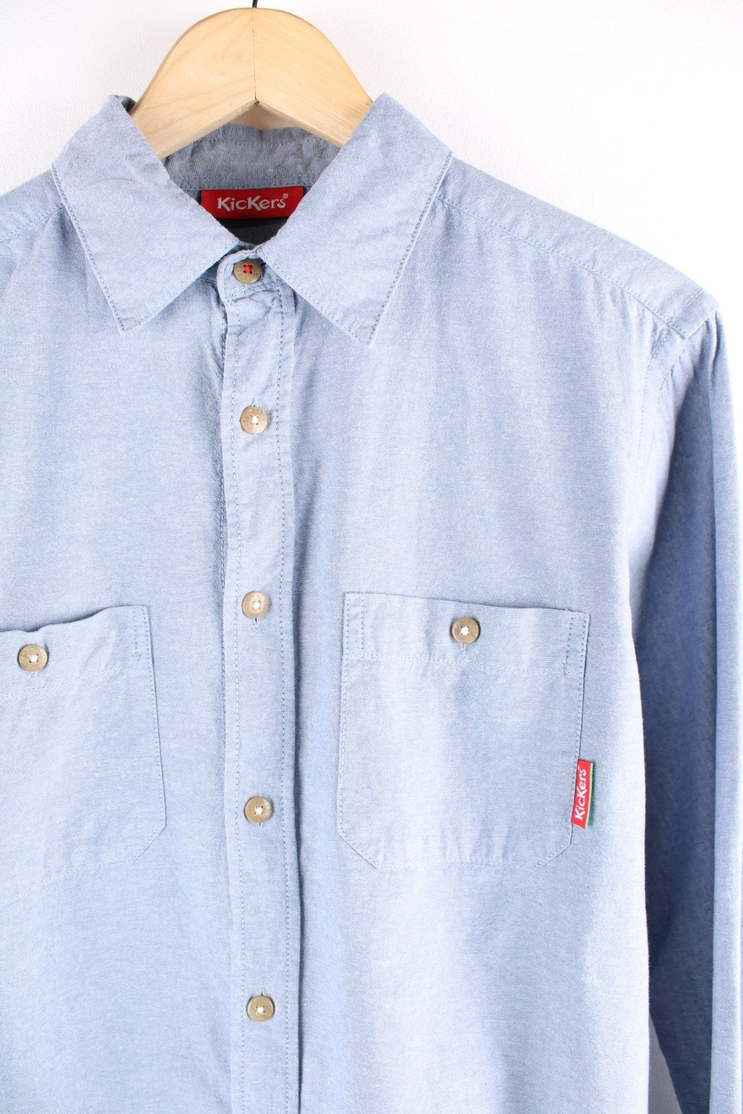 Kickers denim shirt in a light blue wash, with two buttoned pockets and a red logo tab.