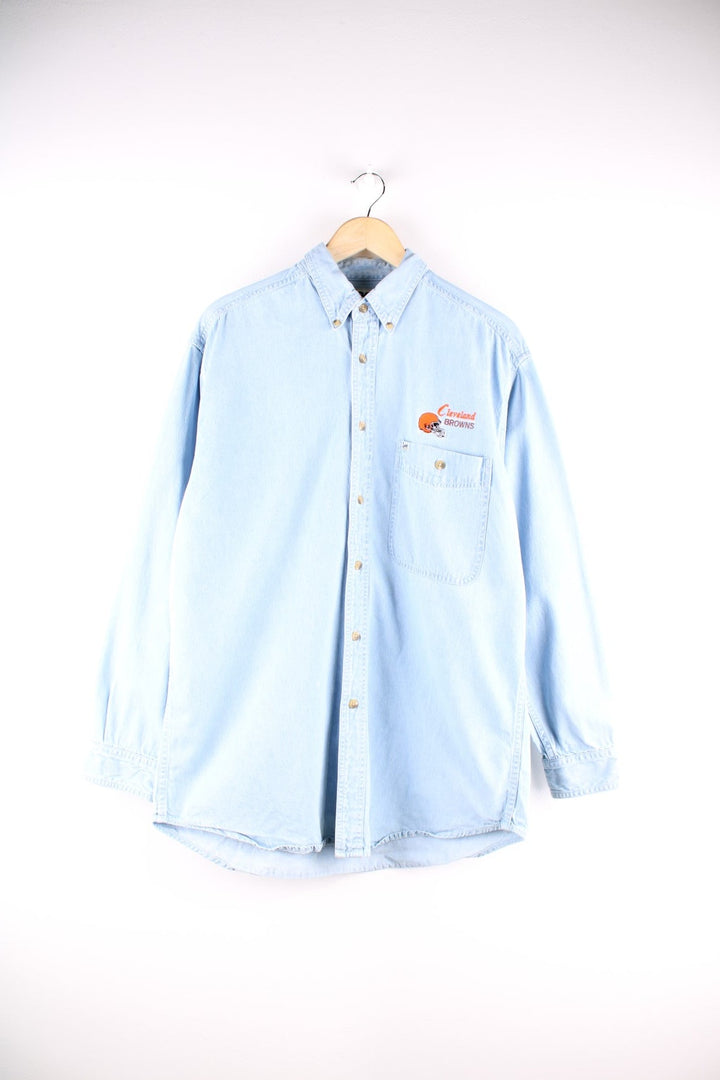 Lee Sport denim shirt in a light blue wash, with the Cleveland Browns team logo embroidered on the chest in orange and brown and a small Lee Sport logo tag.