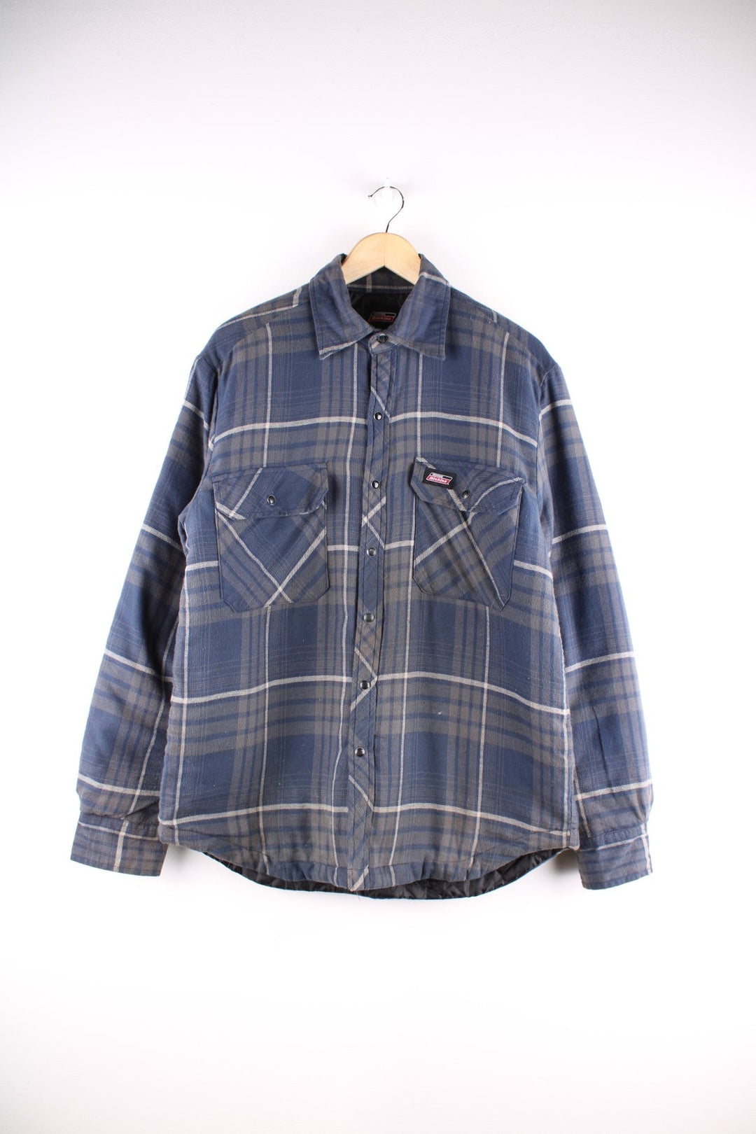 Dickies quilted check shacket in blue and grey check with snap closure, two snap close pockets, and a logo patch on the chest.