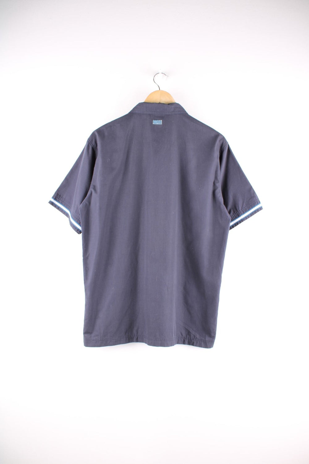 Adidas short-sleeved shirt in blue-grey with concealed button closure, white accent bands on the sleeves, one slit pocket on the chest, and an embroidered logo.