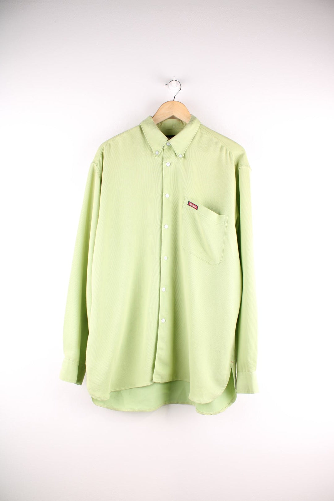 Kickers button-down shirt in a soft lime green fabric, with one pocket, and a small logo patch in red.