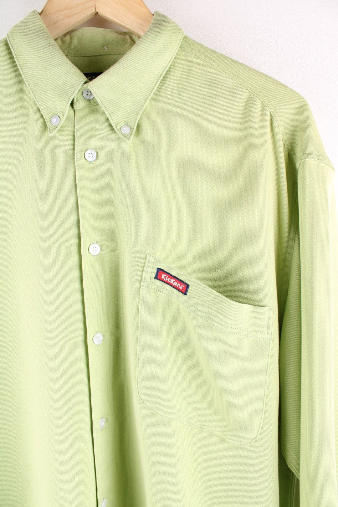 Kickers button-down shirt in a soft lime green fabric, with one pocket, and a small logo patch in red.