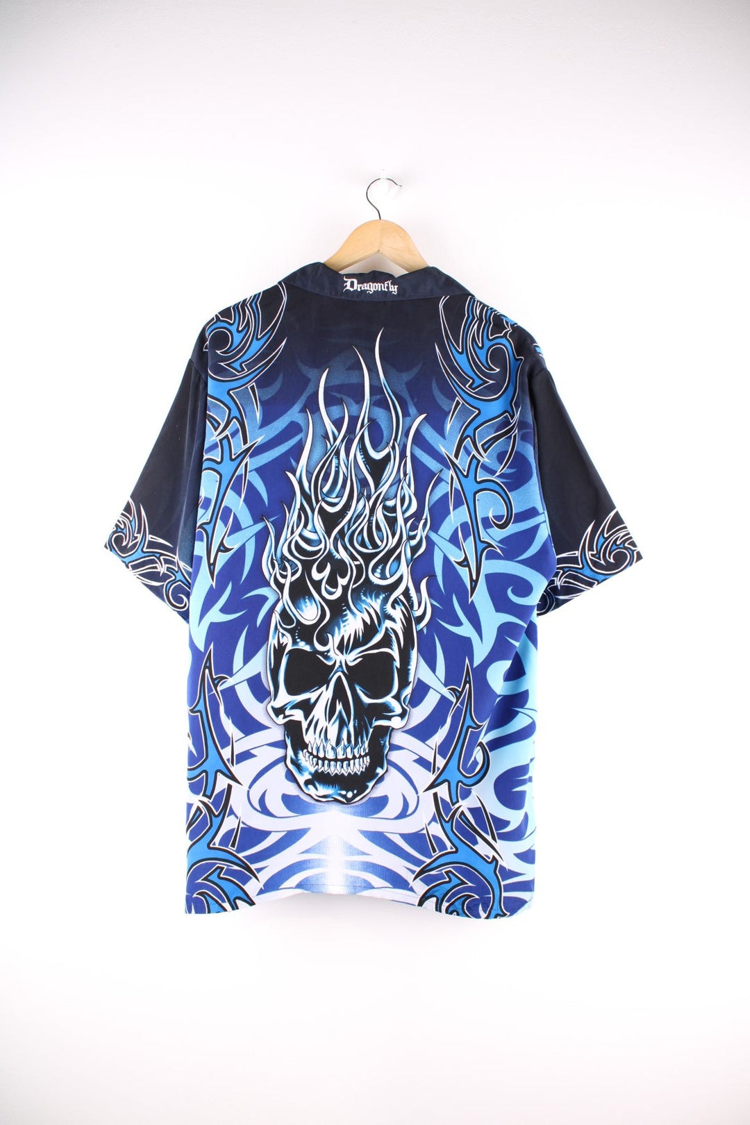 Y2K Flaming Skull short-sleeved Treasure Island Las Vegas shirt in blue with a large front and back design of a flaming skull, and metallic skull and crossbone design buttons.