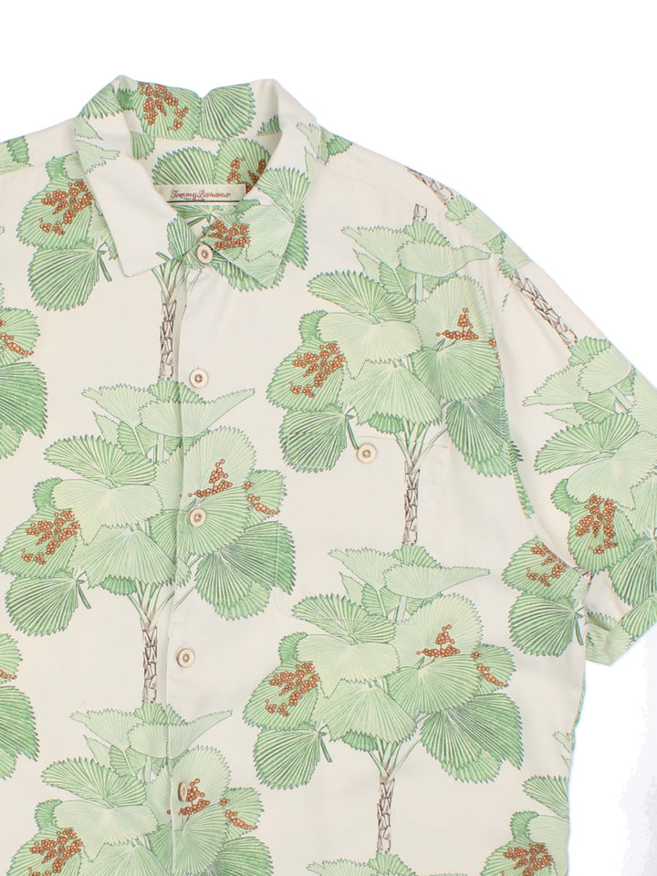 Tommy Bahama Hawiian shirt in a multicoloured colourway. The silk shirt has a green floral print, traditional wooden buttons and a patch pocket on the front.