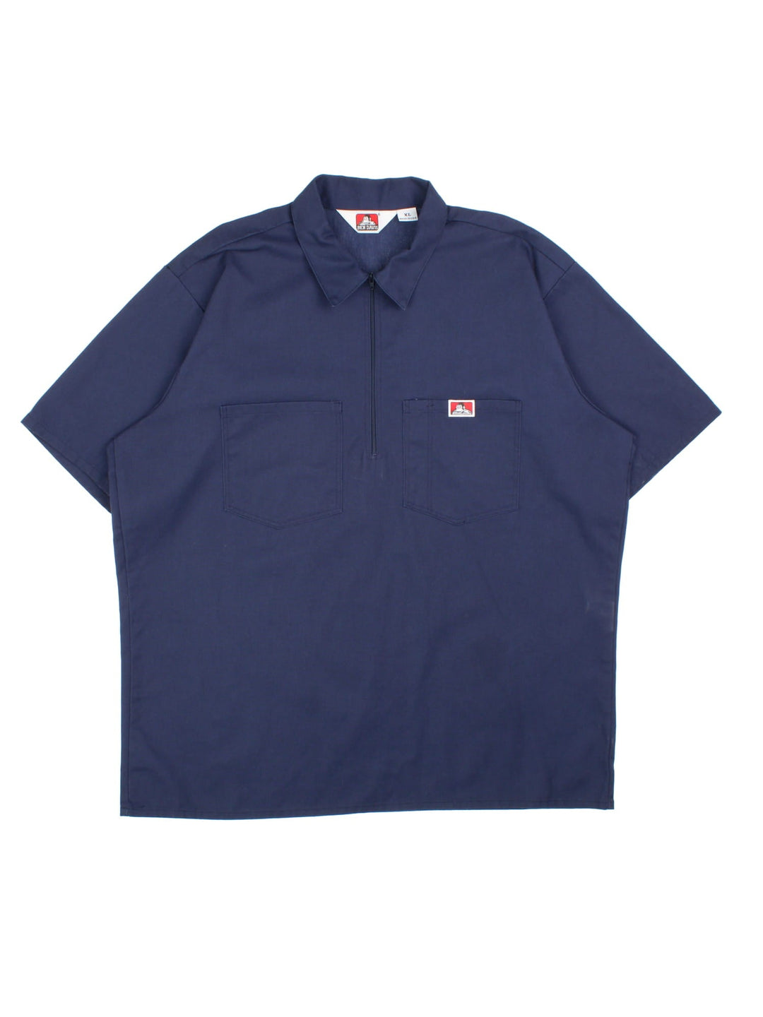 Ben Davis work shirt in a navy blue colourway. The shirt has the classic Ben Davis zip, and double breast pockets, with a pen pocket. Logo is stitched on the front. Made in the USA. 