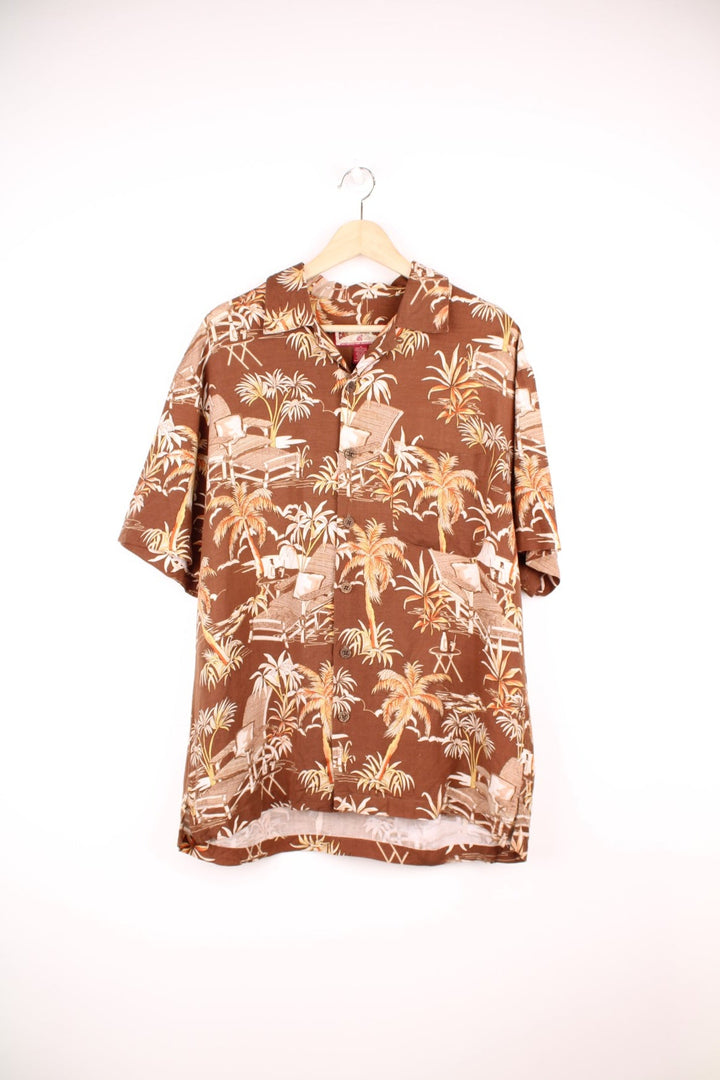 Vintage Caribbean Joe Hawaiian Shirt in a brown colourway with a floral deck chair print all over, button up shirt with a camp collar, and has a chest pocket on the front. 