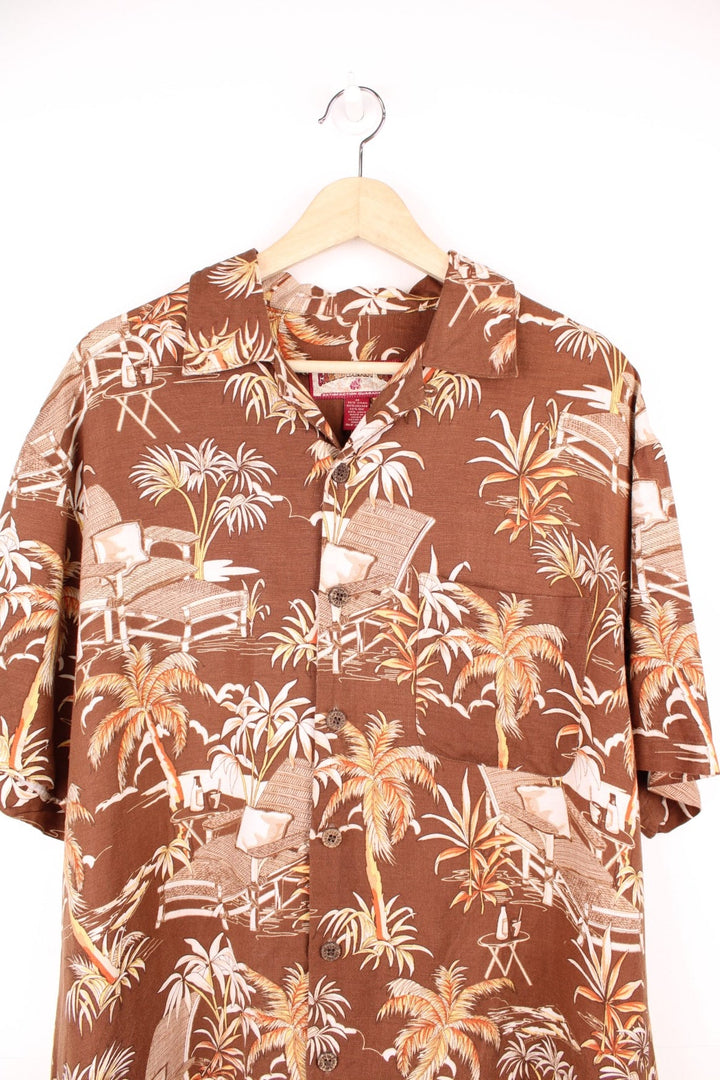 Vintage Caribbean Joe Hawaiian Shirt in a brown colourway with a floral deck chair print all over, button up shirt with a camp collar, and has a chest pocket on the front. 