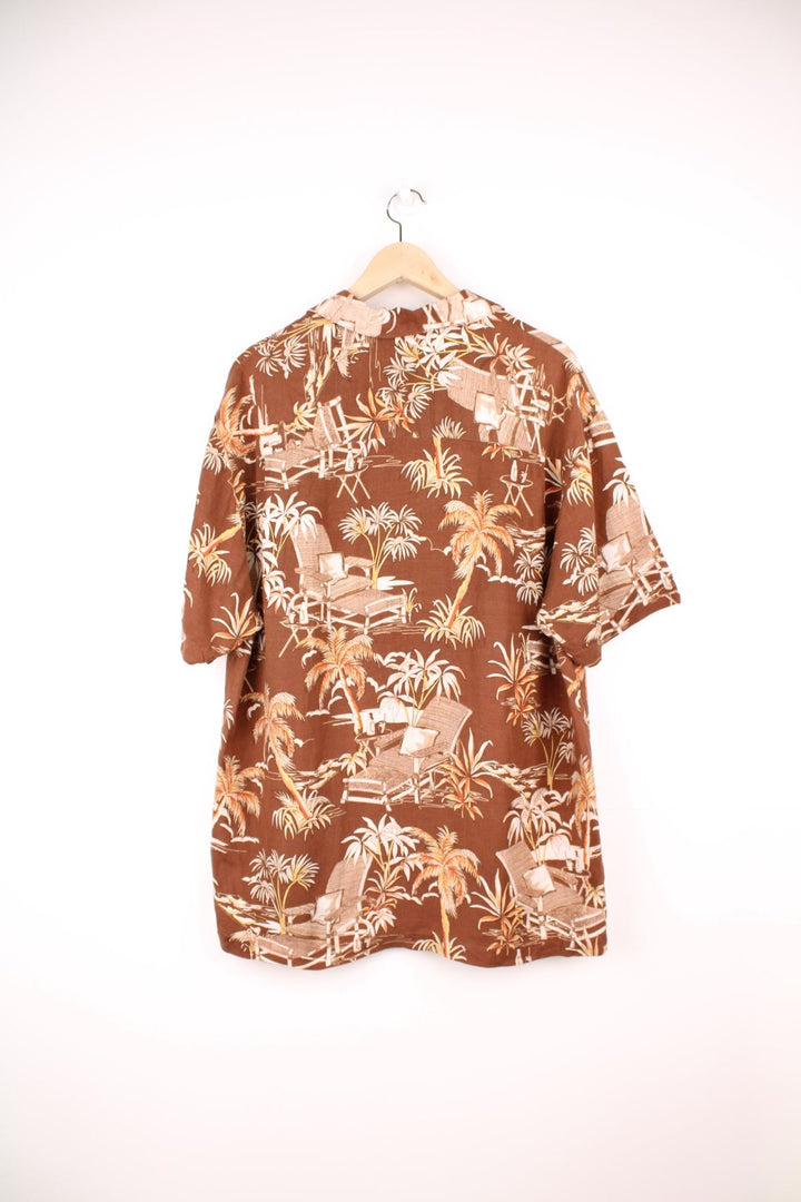 Vintage Caribbean Joe Hawaiian Shirt in a brown colourway with a floral deck chair print all over, button up shirt with a camp collar, and has a chest pocket on the front. 