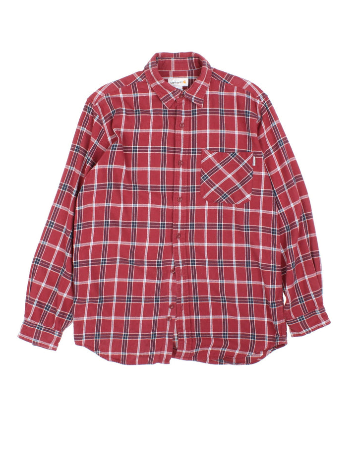 Carhartt Flannel Shirt in a red and black plaid colourway, button up and has a chest pocket with the logo embroidered on the front.