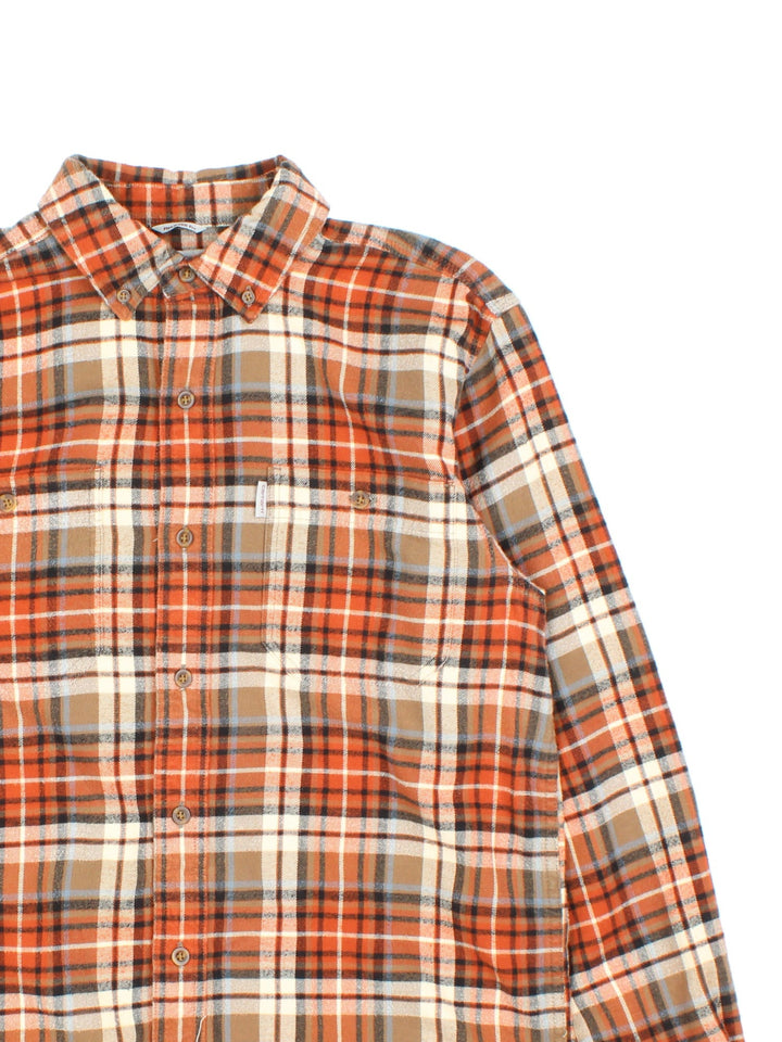 Carhartt Flannel Shirt in a orange, brown and white colourway, button up and has double chest pockets with the logo embroidered on the front.