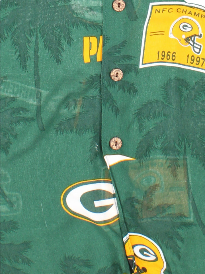 Green Bay Packers NFL Hawaiian Shirt in a green colourway, button up and has a chest pocket, and the team logo printed all over along with palm tree graphics.