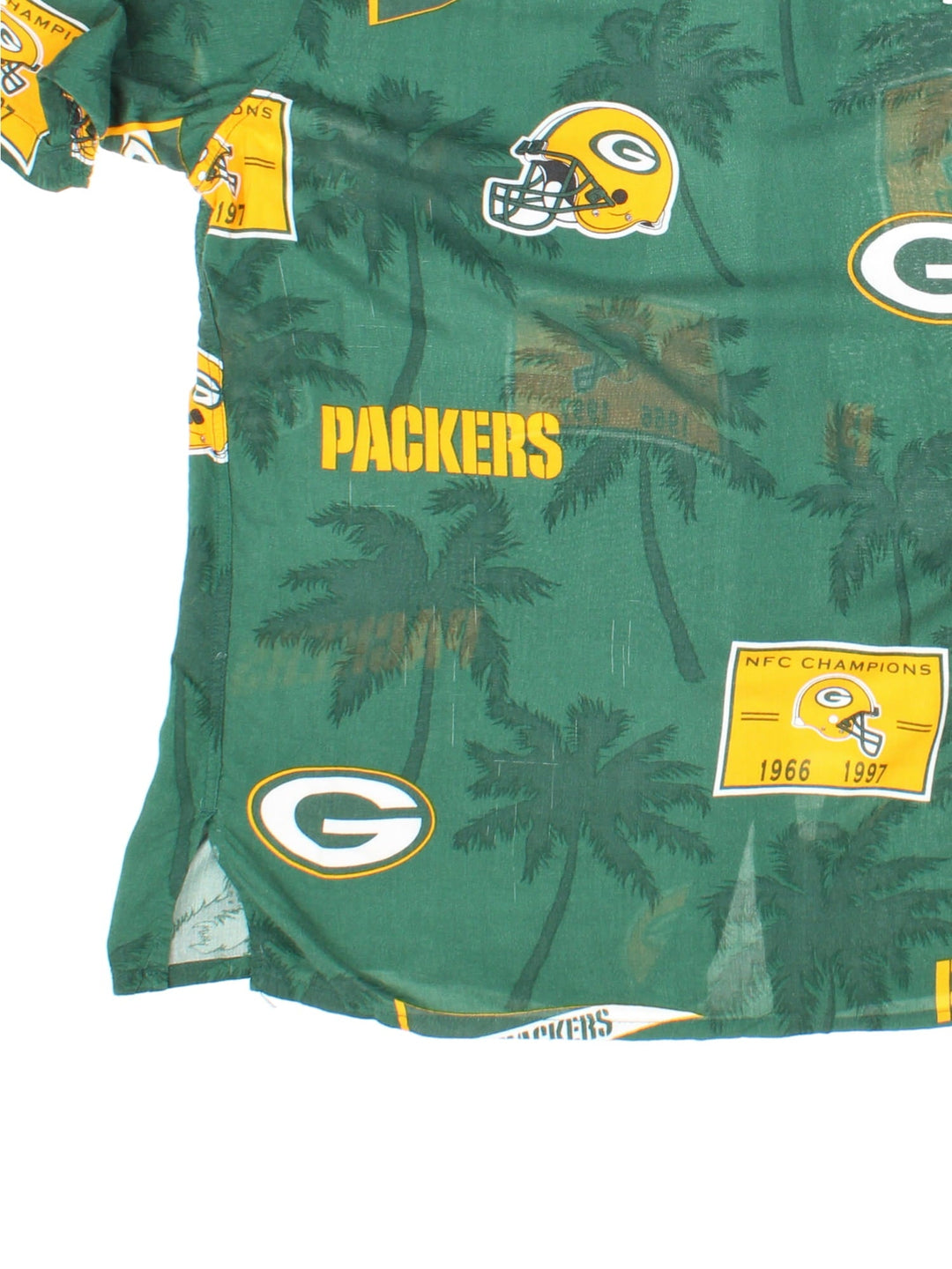 Green Bay Packers NFL Hawaiian Shirt in a green colourway, button up and has a chest pocket, and the team logo printed all over along with palm tree graphics.