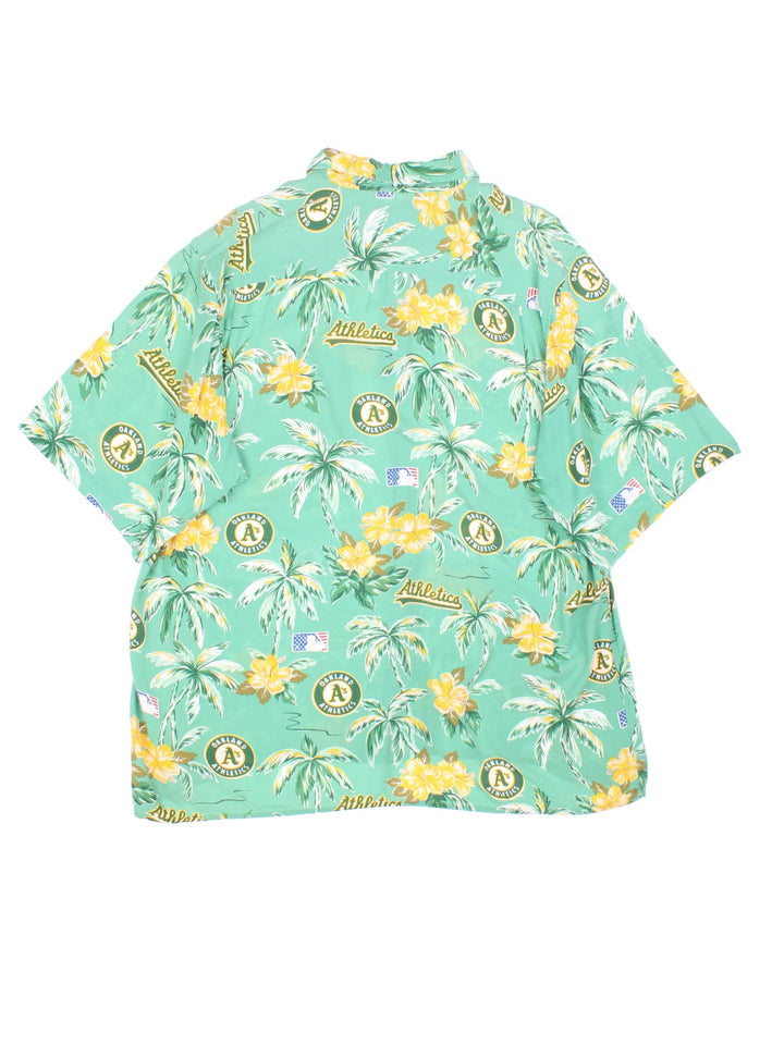 Oakland Athletics MLB Hawaiian Shirt in a green colourway, button up with a chest pocket, and has the logo and palm tree graphic printed all over.