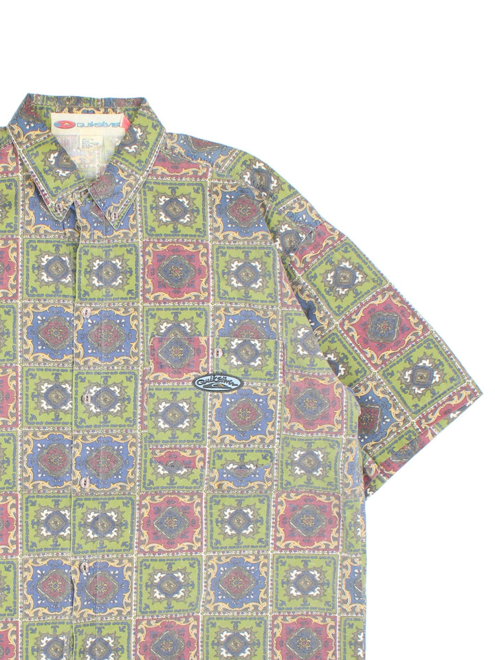 Quiksilver Patterned Short Sleeve Surf Shirt in a green, blue and red colourway, button up and has a chest pocket with the logo embroidered on the front.