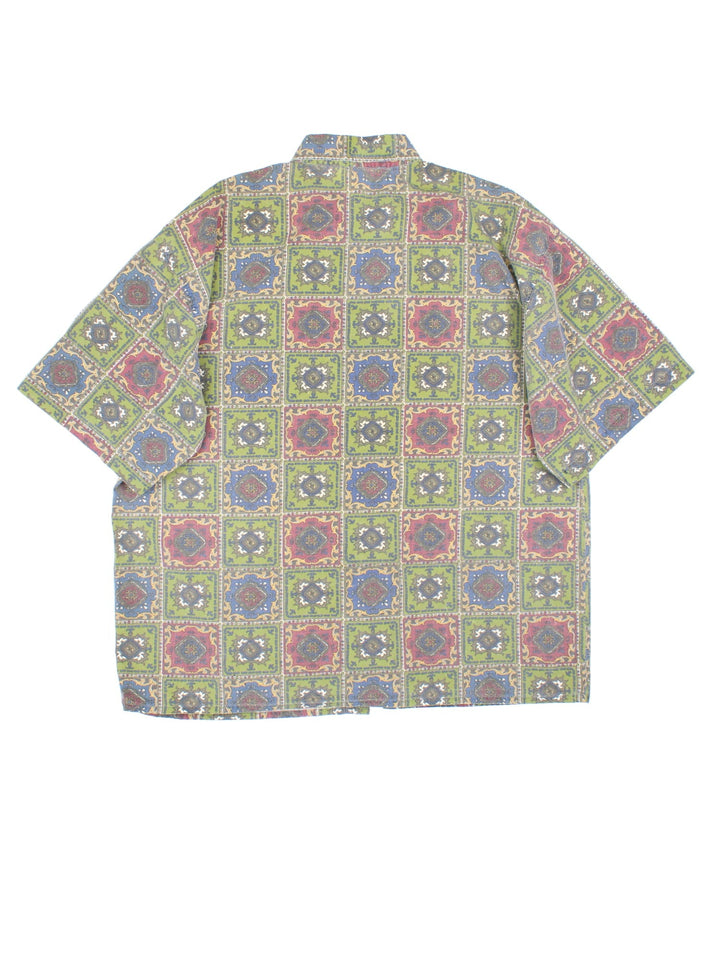 Quiksilver Patterned Short Sleeve Surf Shirt in a green, blue and red colourway, button up and has a chest pocket with the logo embroidered on the front.