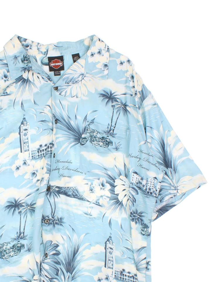 Harley-Davidson Hawaiian Shirt in a blue and white colourway, button up with a camp collar, has a chest pocket and the spell out logo and floral graphic printed all over.