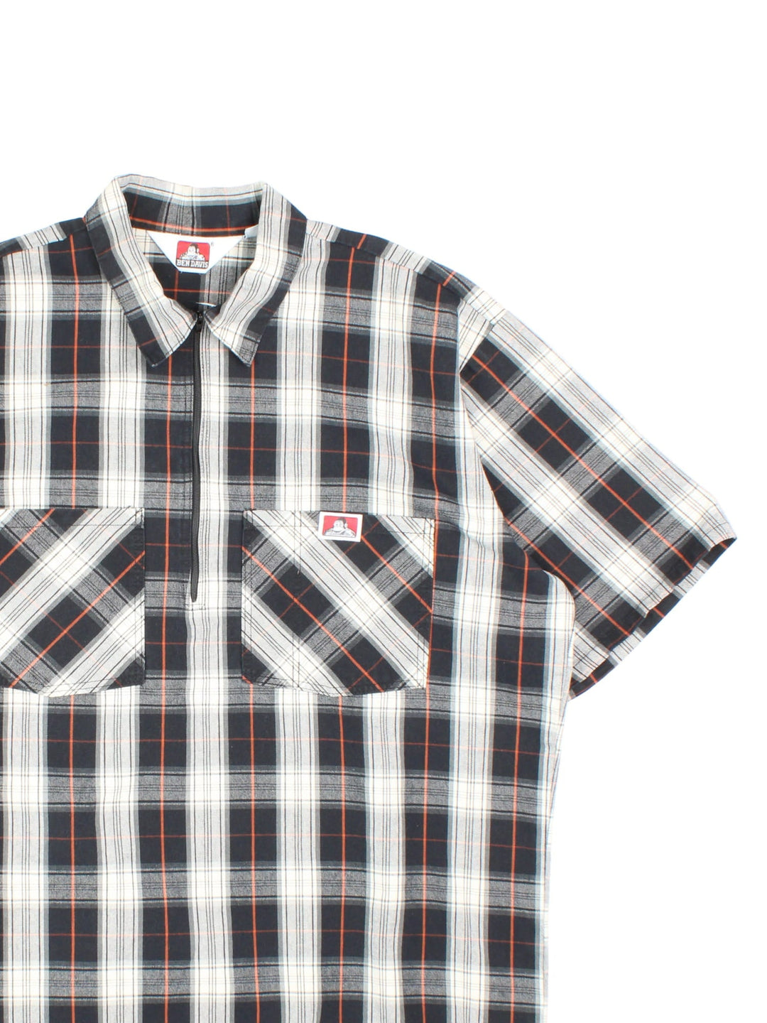 Ben Davis Work Shirt in a black, white, grey and orange plaid colourway, half zip pullover, and has double chest pockets with the logo embroidered on the front.