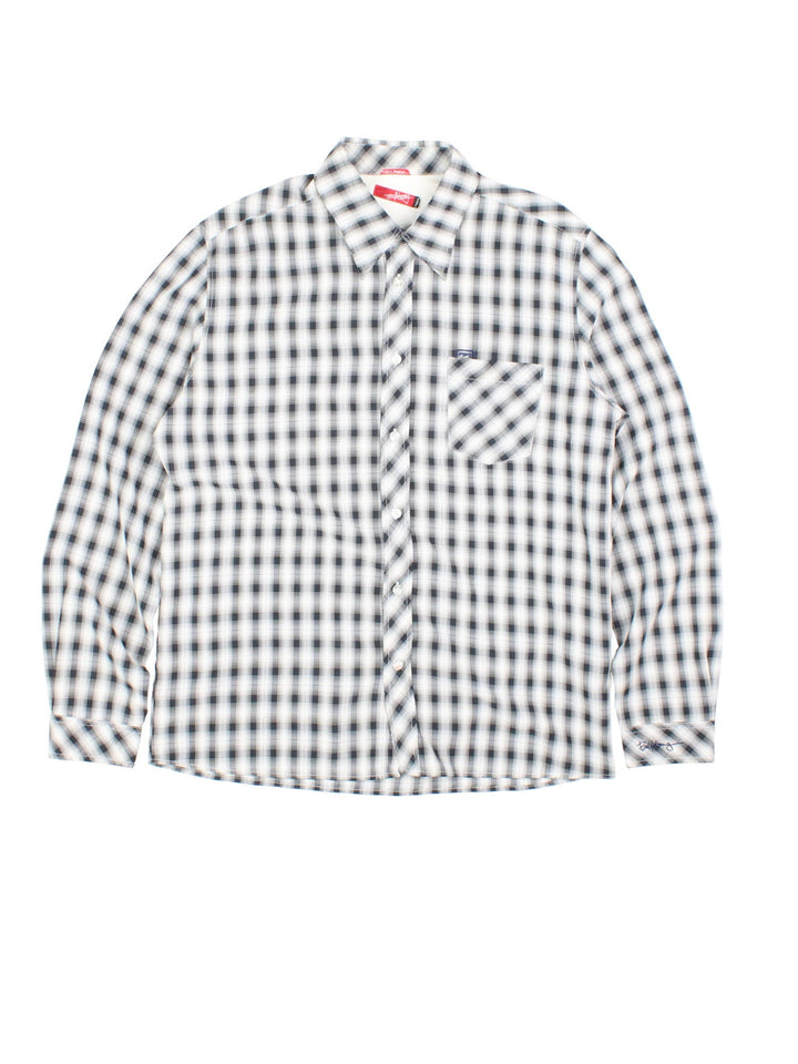 Billabong Checkered Shirt in a white and black colourway, button up and has a chest pocket with the logo embroidered on the front and left sleeve.