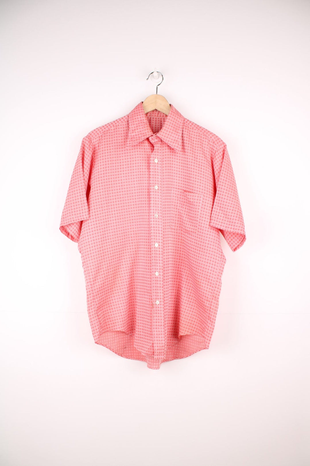 Vintage 70s pink and red patterned shirt with a dagger collar and pocket on the chest. 