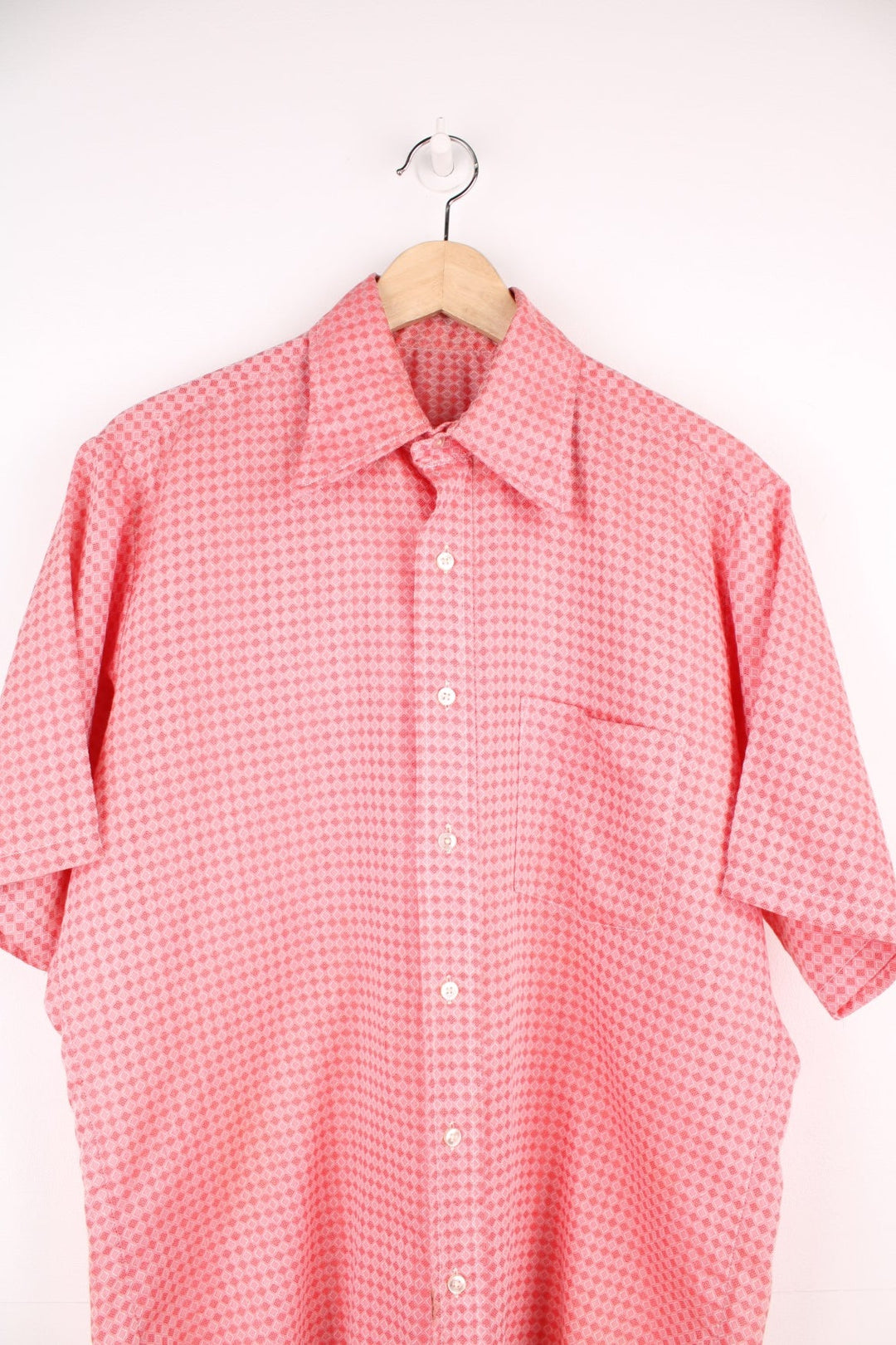 Vintage 70s pink and red patterned shirt with a dagger collar and pocket on the chest. 