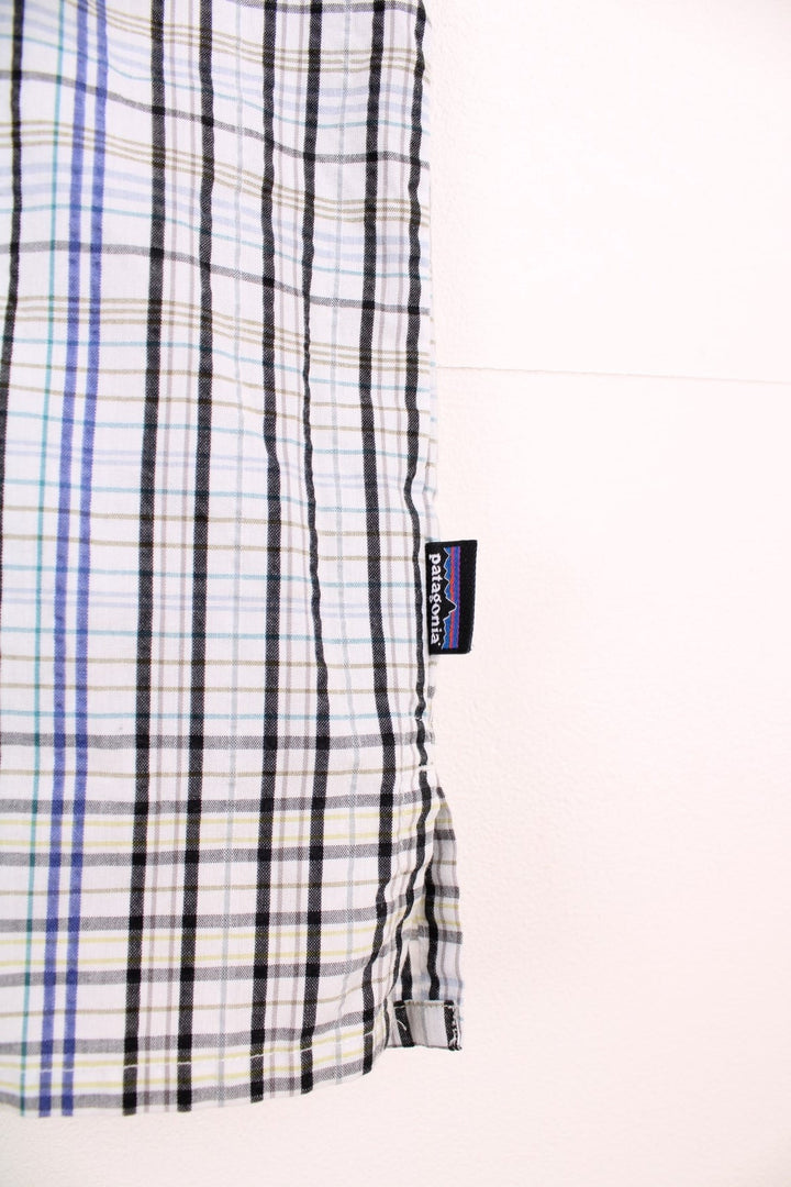 Patagonia plaid button through shirt in white, green, black and blue with chest pocket. 