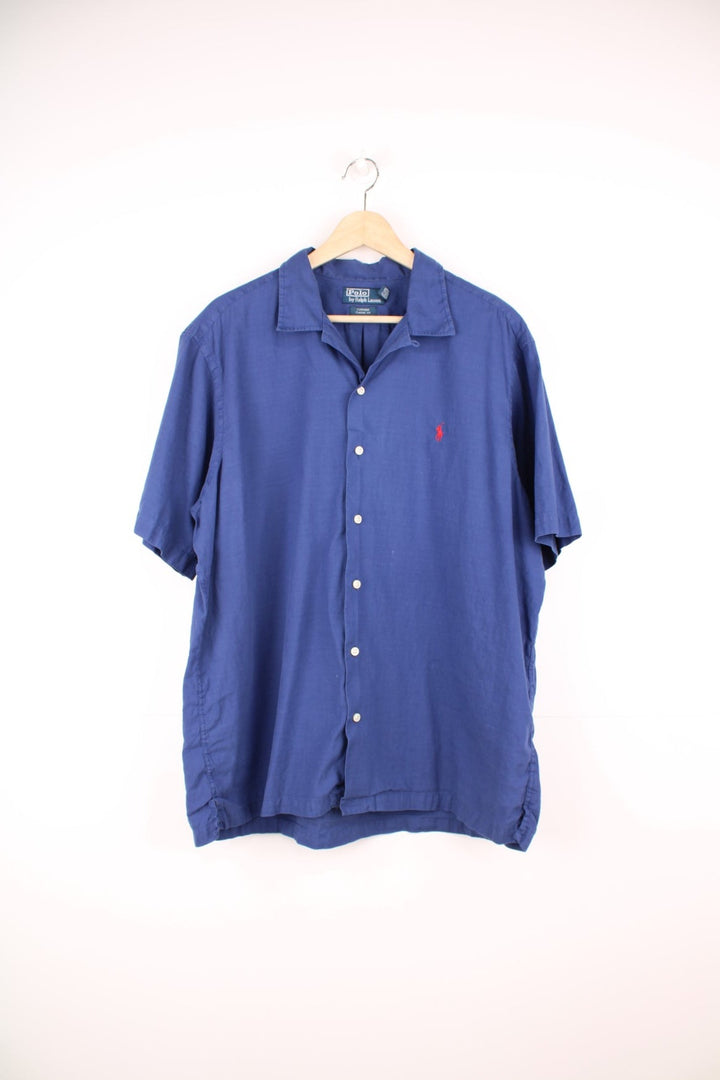 Dark blue short-sleeved Polo Ralph Lauren shirt with white buttons and the classic Polo logo embroidered in red.