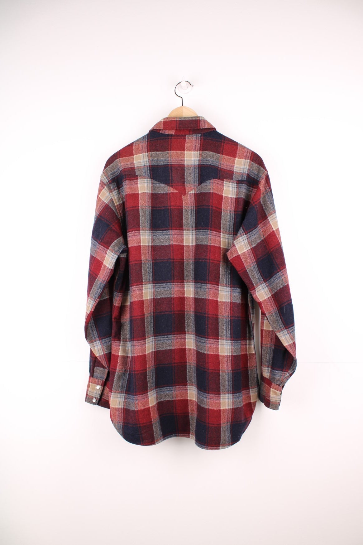 Vintage Pendleton western style Pearl Snap button through wool plaid shirt in red, blue and beige. Features chest pockets. 