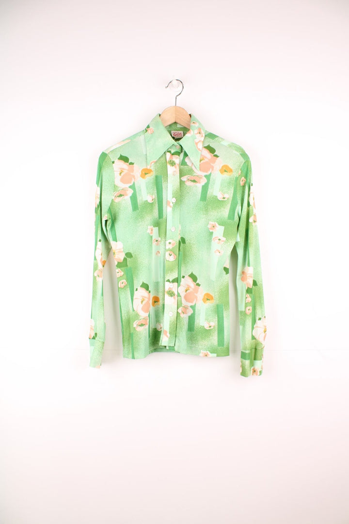 Vintage 70s Styled by Sybil green button through blouse with pink floral pattern and a dagger collar.