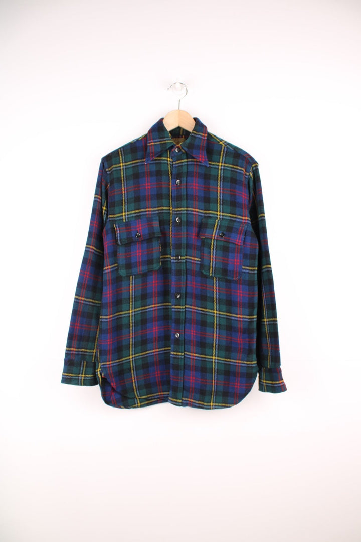 Vintage 40s Congress Sportswear button through wool plaid shirt in blue, green, red and yellow. Features chest pockets, a dagger collar and suede elbow pads. 