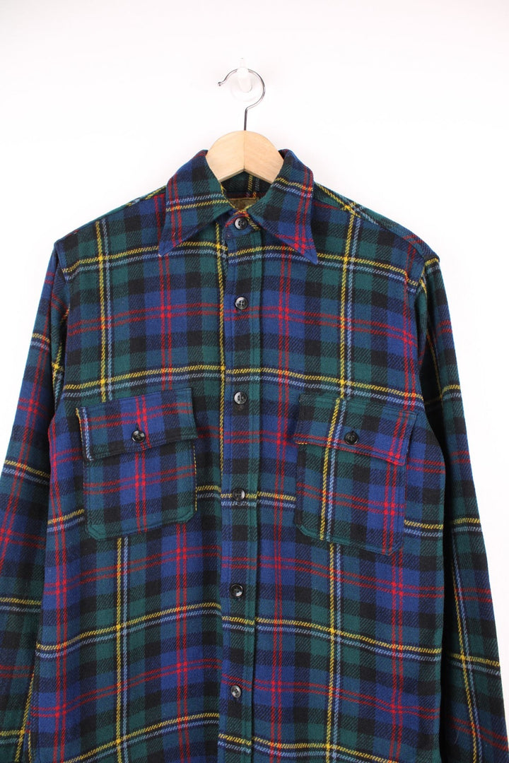 Vintage 40s Congress Sportswear button through wool plaid shirt in blue, green, red and yellow. Features chest pockets, a dagger collar and suede elbow pads. 