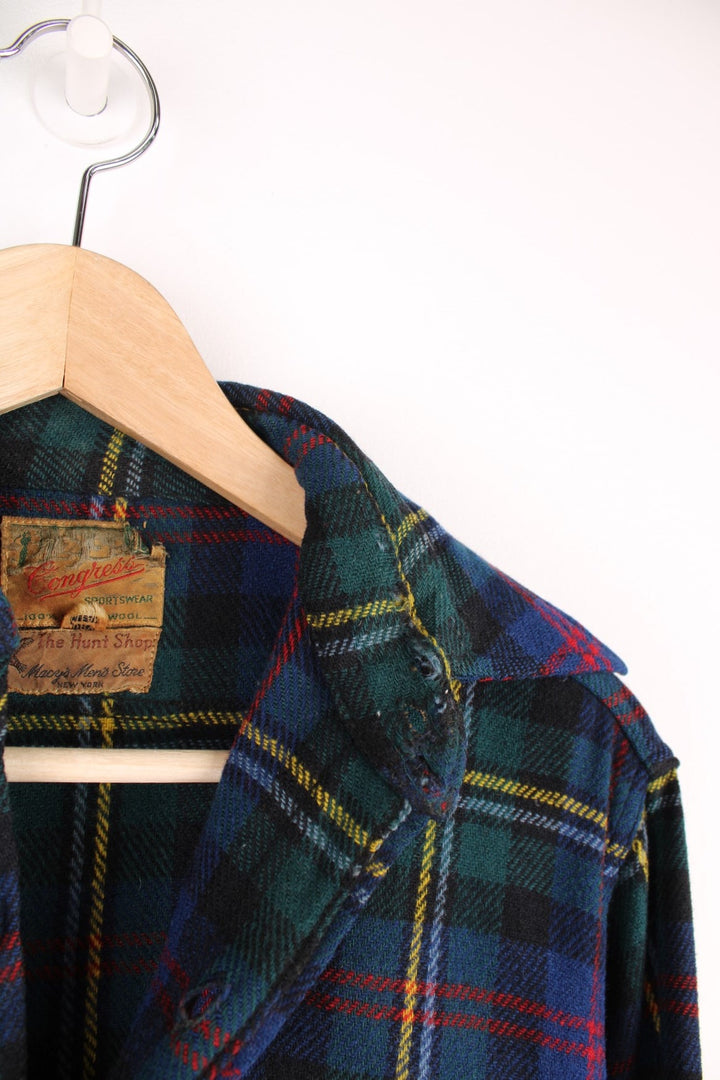 Vintage 40s Congress Sportswear button through wool plaid shirt in blue, green, red and yellow. Features chest pockets, a dagger collar and suede elbow pads. 