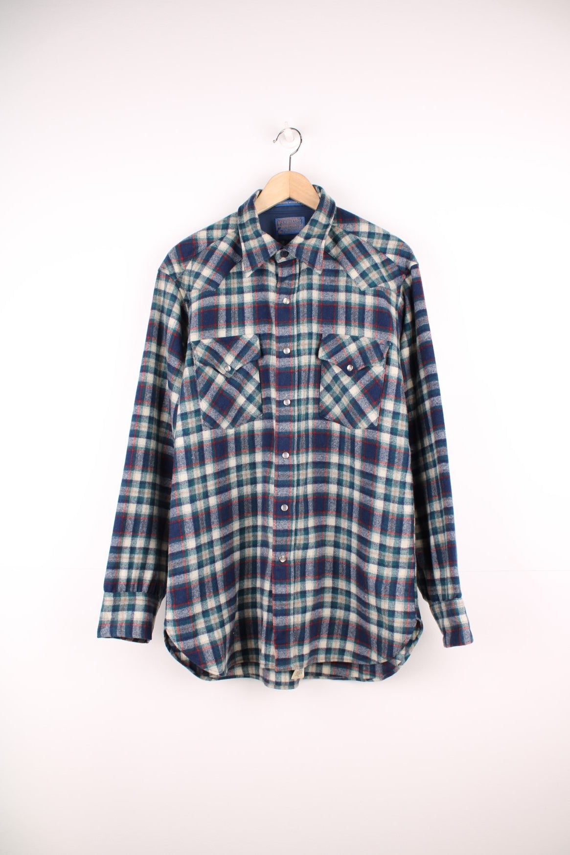 Vintage Pendleton wool plaid Pearl Snap shirt in blue, white and red. Features chest pockets and Western style yolk. 