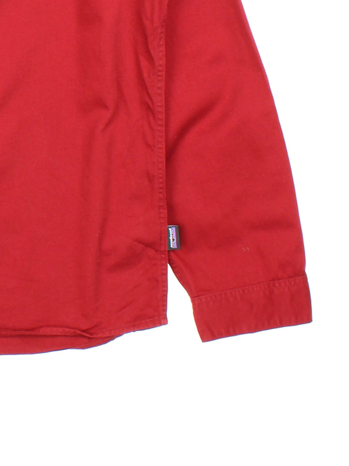 Patagonia overshirt in red with button closure and two chest pockets.