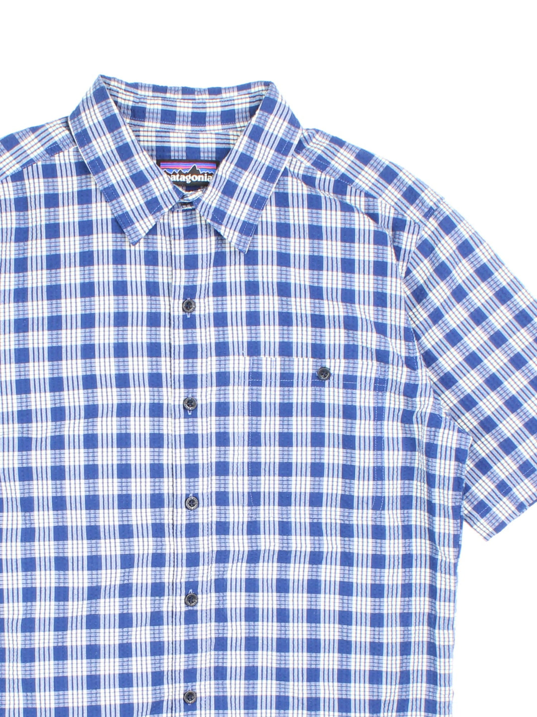 Patagonia short-sleeved textured shirt in blue and white checkered colourway with one pocket.