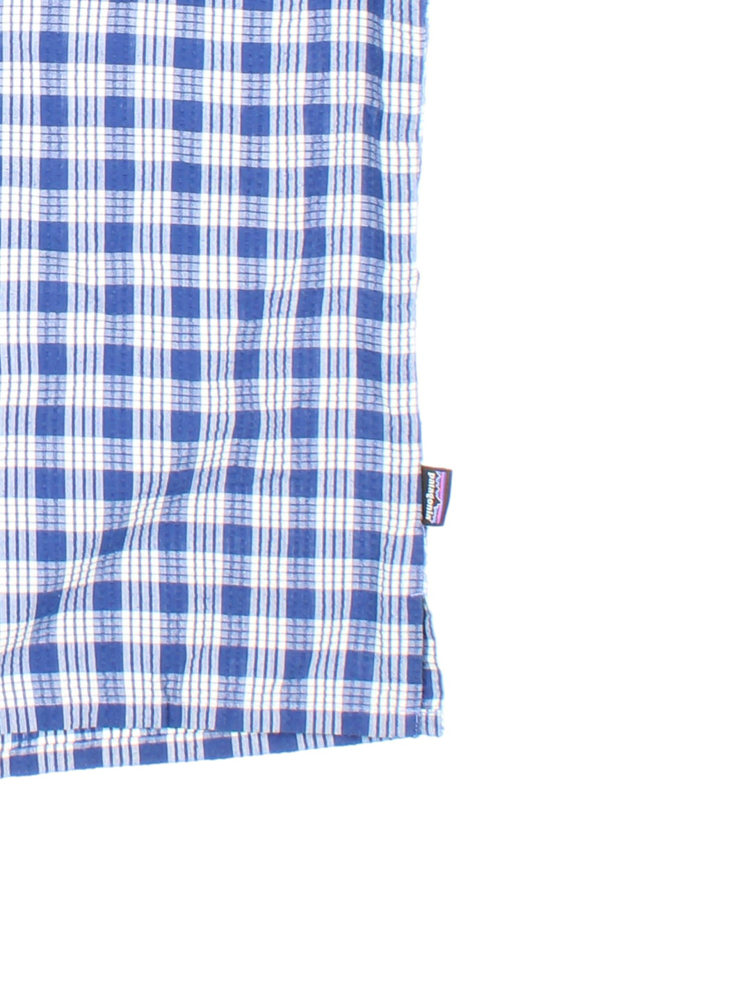 Patagonia short-sleeved textured shirt in blue and white checkered colourway with one pocket.