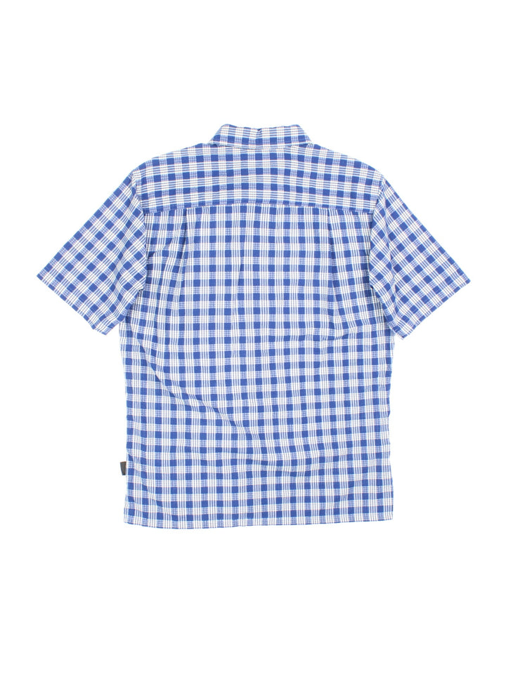 Patagonia short-sleeved textured shirt in blue and white checkered colourway with one pocket.