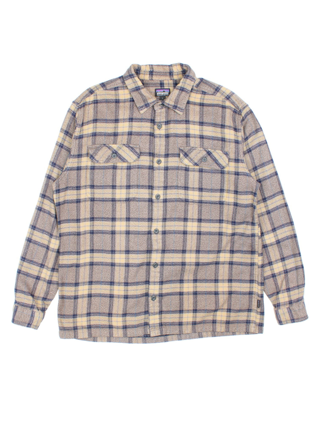 Patagonia check shirt in brown, blue and yellow, with two pockets and a small logo tab on the lower left seam.