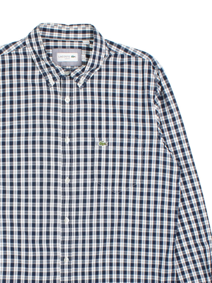 Lacoste Shirt in a blue checked colourway, button up with the logo embroidered on the front.