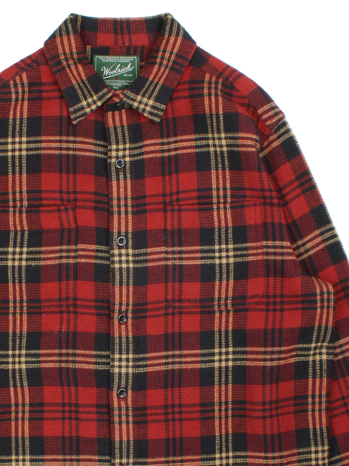 Woolrich Flannel Shirt in a red colourway with checked pattern and waffle texture. Classic button up with front pocket.