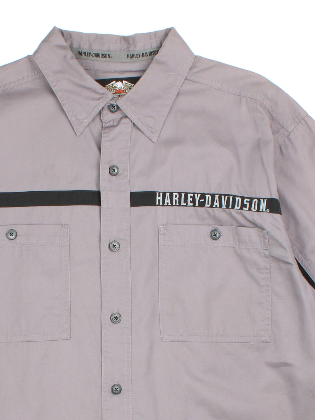 Harley-Davidson Shirt in a grey colourway with black panel detailing across the front,sleeves and back. Classic button up with two front pockets, Large brand name and flame graphic on the back.